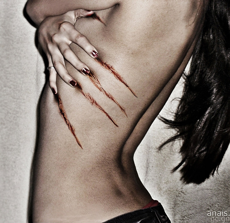 Art Photo of long haird woman's side, scratched her ribs which left marks